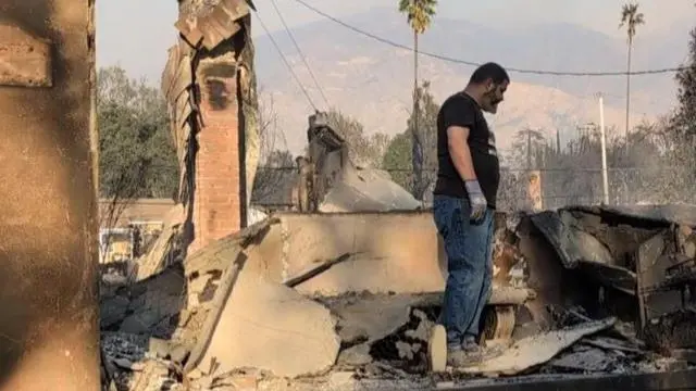 One resident searches through rubble