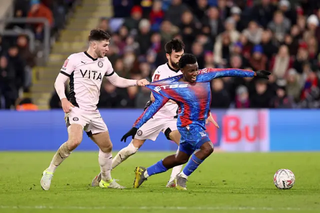 Eddie Nketiah of Crystal Palace is pulled back by Ethan Pye