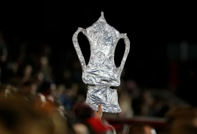 A foil FA Cup trophy at the game between Oxford and Exeter