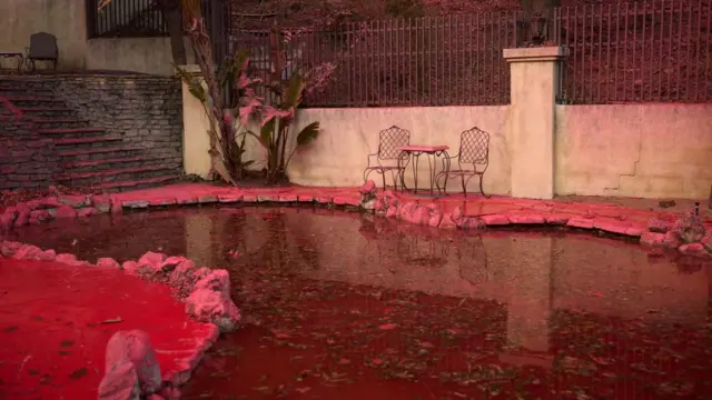 A backyard swimming pool is bright pink