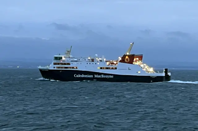 A black and white ship with red funnels