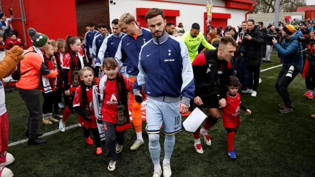 Tottenham Hotspur's James Maddison and Tamworth's Ben Milnes walk onto the pitch