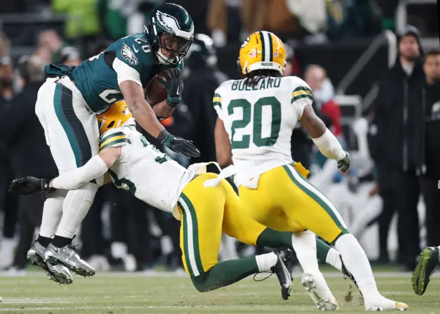 Saquon Barkley #26 of the Philadelphia Eagles is tackled by Evan Williams #33 of the Green Bay Packers