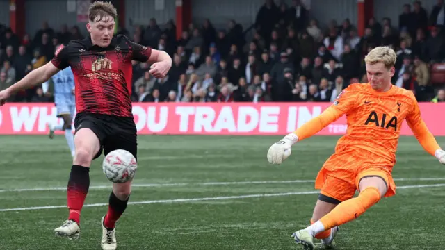 Tamworth's Dan Creaney in action with Tottenham Hotspur's Antonin Kinsky