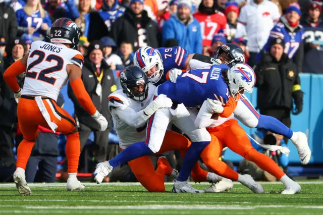 osh Allen #17 of the Buffalo Bills carries the ball against the Denver Broncos