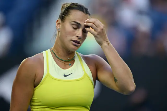 Aryna Sabalenka scratches her head