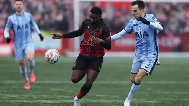 Tottenham Hotspur's Sergio Reguilon in action with Tamworth's Beck-Ray Enoru