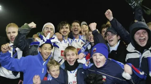 Martin Reeves, Neil Moore and Matty Collins of Nuneaton celebrate with fans