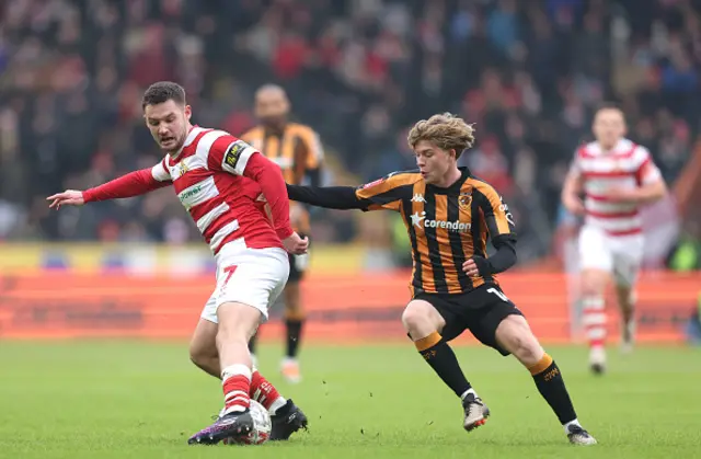 Luke Molyneux of Doncaster Rovers is challenged by Harry Vaughan