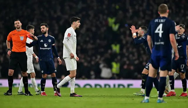 Diogo Dalot (3R) reacts after being shown a red card