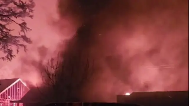 Flames and smoke above a house