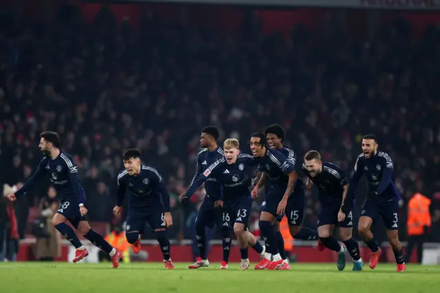 Man Utd players celebrate after going through against Arsenal