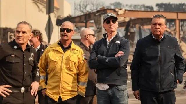 California Governor Gavin Newsom (2-R) and Democratic US Senator Alex Padilla of California (R) watch firefighters battle the Palisades wildfire in the Pacific Palisades neighborhood of Los Angeles