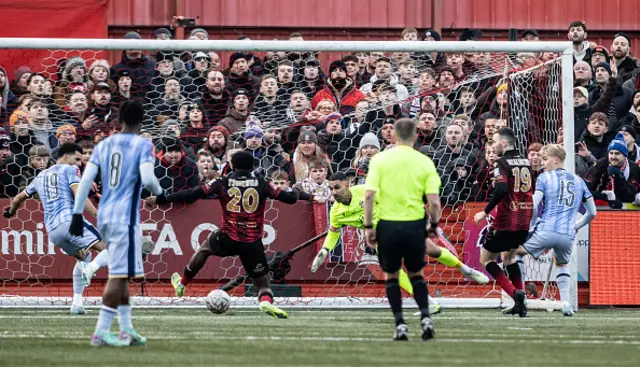 Tamworth's Nathan Tshikuna (no.20) scores an own goal