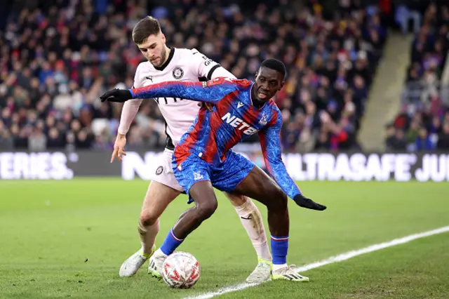 Ismaila Sarr of Crystal Palace battles for possession with Ethan Pye