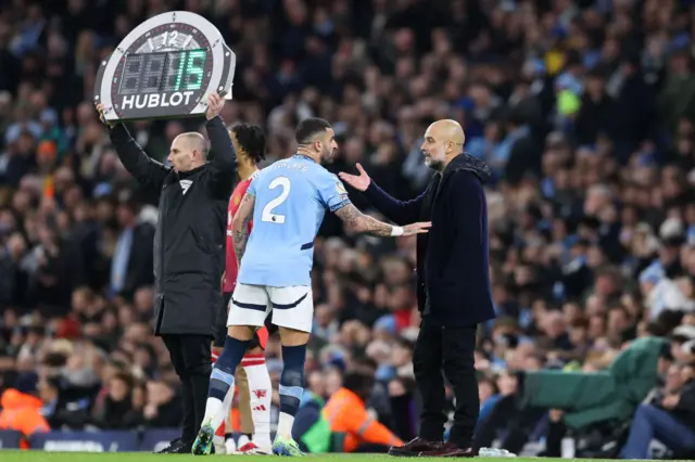 Kyle Walker talks to Pep Guardiola