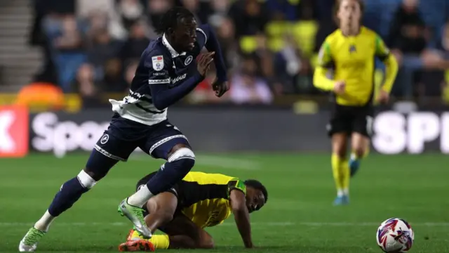 Romain Esse dribbles the ball forward for Millwall during a Championship match against Plymouth