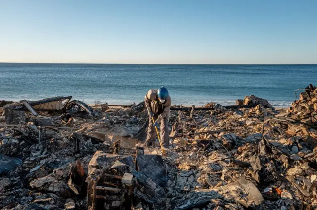 A man sifts through belongings at his home