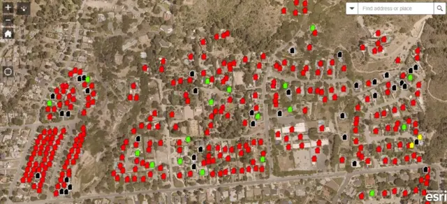 Map showing Eaton fire, with predominantly red markers covering a neighbourhood along with scattered green, orange, yellow and black markers