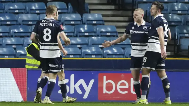 Casper De Norre is joined in celebration by his Millwall team-mates