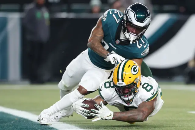 Josh Jacobs dives for the end zone while playing for the Green Bay Packers against the Philadelphia Eagles