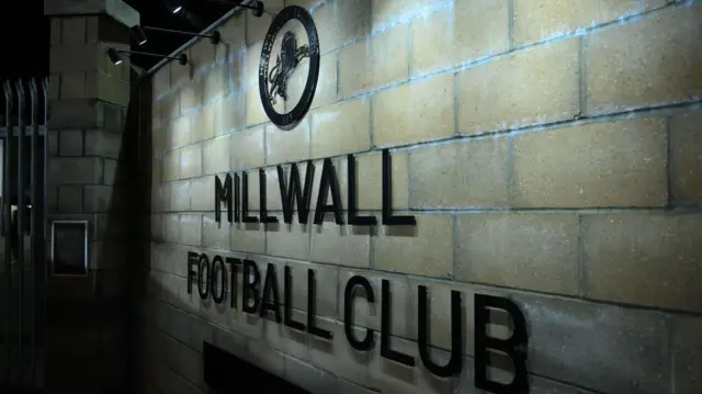 A sign on the wall outside The Den displaying the club crest and "Millwall Football Club"