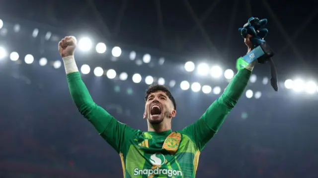 Manchester United goalkeeper Altay Bayindir celebrates beating Arsenal