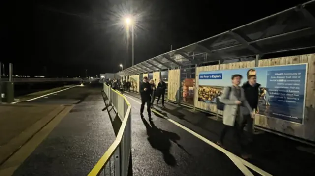 Foot passengers begin to board