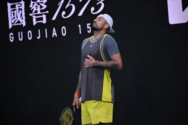 Nick Kyrgios stretches out his abs