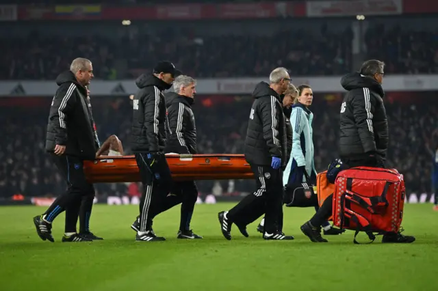 Gabriel Jesus being carried off on a stretcher