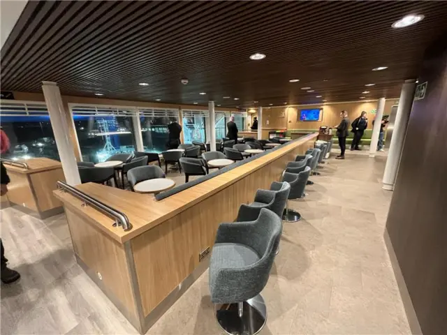 Interior of Glen Sannox - rows of grey soft seating next to wooden tables with large window views