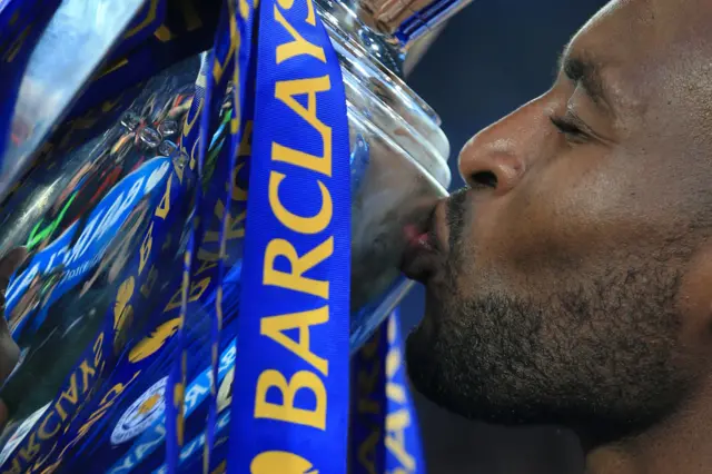 Wes Morgan kisses the Premier League trophy