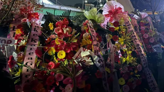 Flowers left at the scene by Yoon supporters