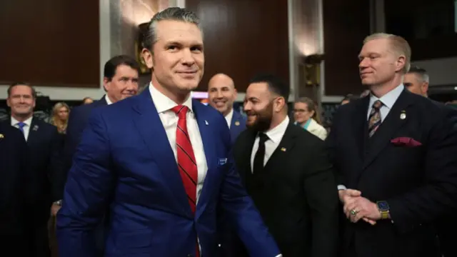 Pete Hegseth walks into the chamber