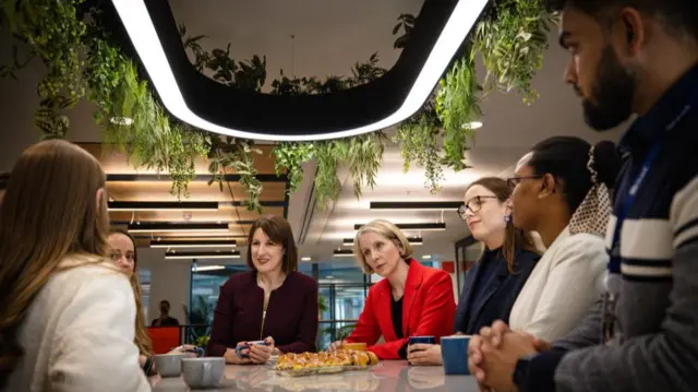 Rachel Reeves and Emma Reynolds sit at the centre of the image surrounded by others sitting in a circle formation