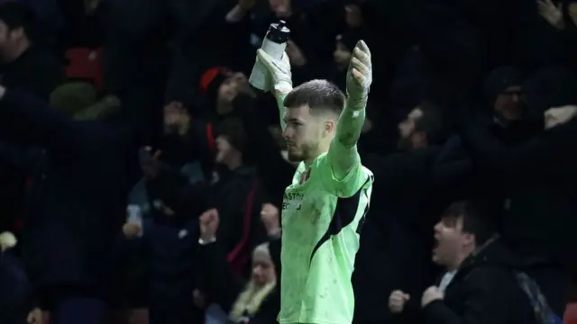 Josh Keeley raises his arms in celebration as Brisbane Road savours FA Cup success over Derby