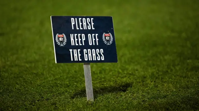 DUNDEE, SCOTLAND - JANUARY 14: A sign saying 'keep off the grass' during a William Hill Premiership match between Dundee and Celtic at the Scot Foam Stadium at Dens Park, on January 14, 2025, in Dundee, Scotland. (Photo by Craig Foy / SNS Group)