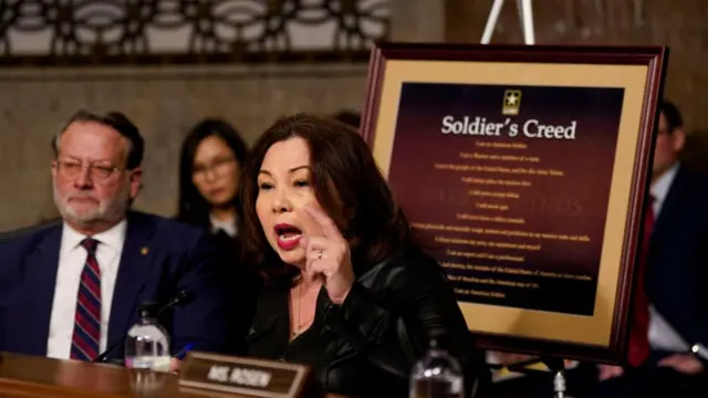 An image of the "Soldier's Creed" behind Senator Tammy Duckworth