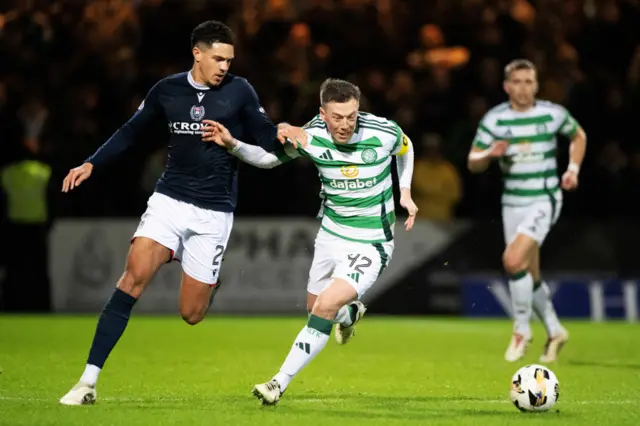 DUNDEE, SCOTLAND - JANUARY 14: Celtic's Callum McGregor and Dundee's Ethan Ingram in action during a William Hill Premiership match between Dundee and Celtic at the Scot Foam Stadium at Dens Park, on January 14, 2025, in Dundee, Scotland. (Photo by Paul Devlin / SNS Group)