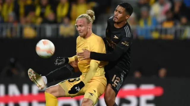 Lars-Jorgen Salvesen in action for Bodo/Glimt in 2022 as he controls the ball under pressure from Arsenal's William Saliba