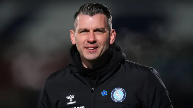 Matt Bloomfield is pictured in a Wycombe Wanderers coat, smiling