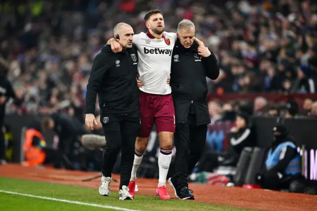 Fulkrug is helped off the pitch by physios