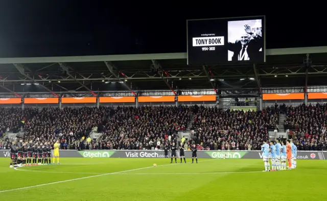 Players gather in the centre circle to remember Tony Book