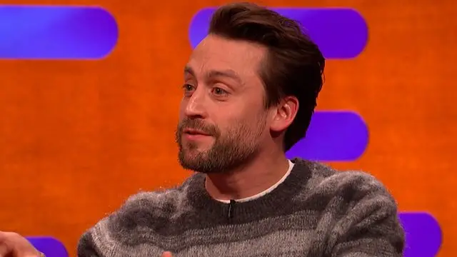 Kieran Culkin pictured against a purple and red backdrop