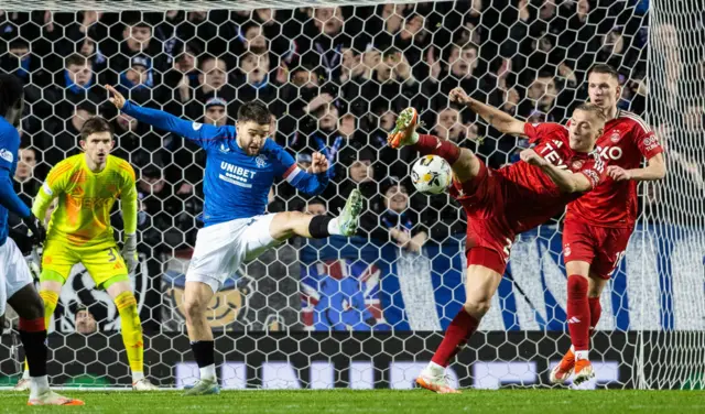 VAR checks for a potential penalty after Rangers' Nicolas Raskin (L) and Aberdeen's Kristers Tobers collide in the box but no penalty is given during a William Hill Premiership match between Rangers and Aberdeen at Ibrox Stadium