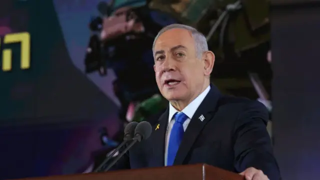 Benjamin Netanyahu speaking into a microphone