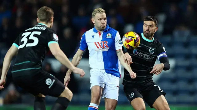 Andreas Weimann of Blackburn challenges Portsmouth for the ball