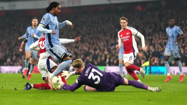 Description Arsenal's Raheem Sterling (left) has his shot saved by Tottenham Hotspur goalkeeper Antonin Kinsky