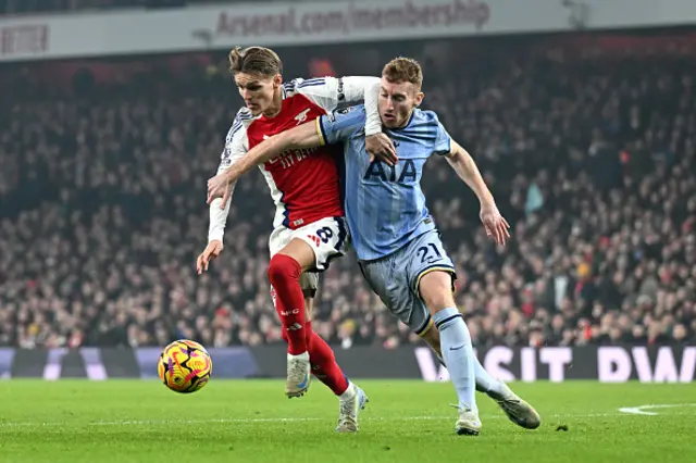 Martin Odegaard of Arsenal and Dejan Kulusevski  battle for the ball