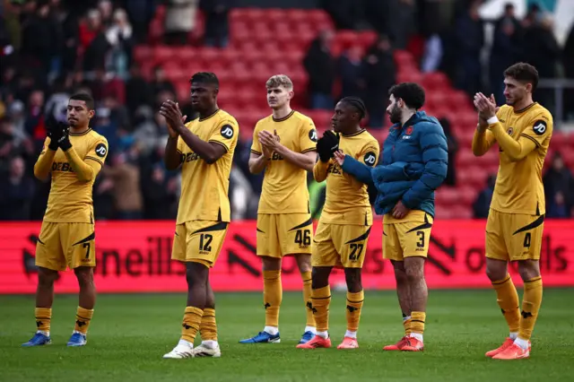 Wolves players clap the travelling fans at full time